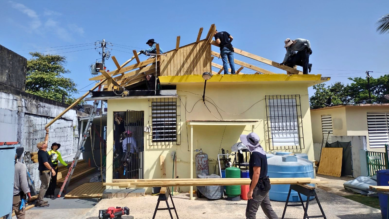 PRoTechos crew rebuilding a wooden roof on a home in Puerto Rico.